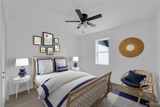 bedroom with hardwood / wood-style floors and ceiling fan