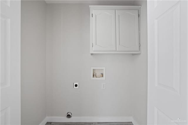 laundry area with baseboards, hookup for an electric dryer, cabinet space, and hookup for a washing machine