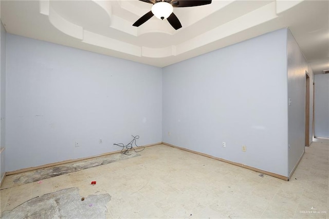 spare room featuring ceiling fan and a tray ceiling