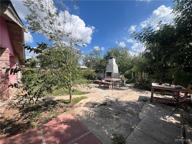 view of patio / terrace featuring an outdoor fireplace