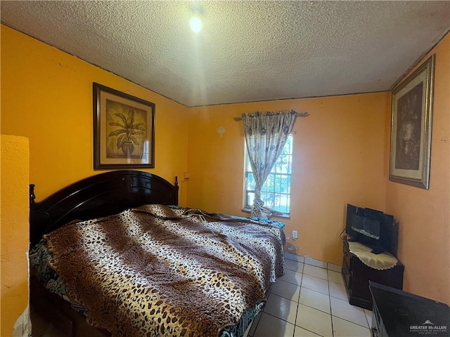 tiled bedroom featuring a textured ceiling