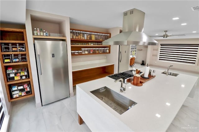 5804 La Quinta Ln, Weslaco, TX 78599 - kitchen featuring stainless steel fridge, island range hood, light marble finish flooring, ceiling fan, and an island with sink