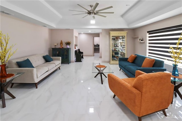 5804 La Quinta Ln, Weslaco, TX 78599 - living area featuring a raised ceiling, ceiling fan, and light marble finish flooring