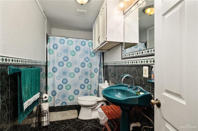 bathroom with walk in shower, tile walls, and toilet