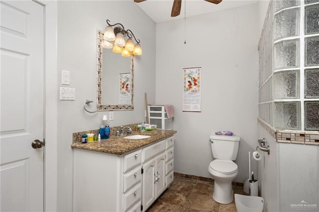 bathroom with ceiling fan, toilet, and vanity