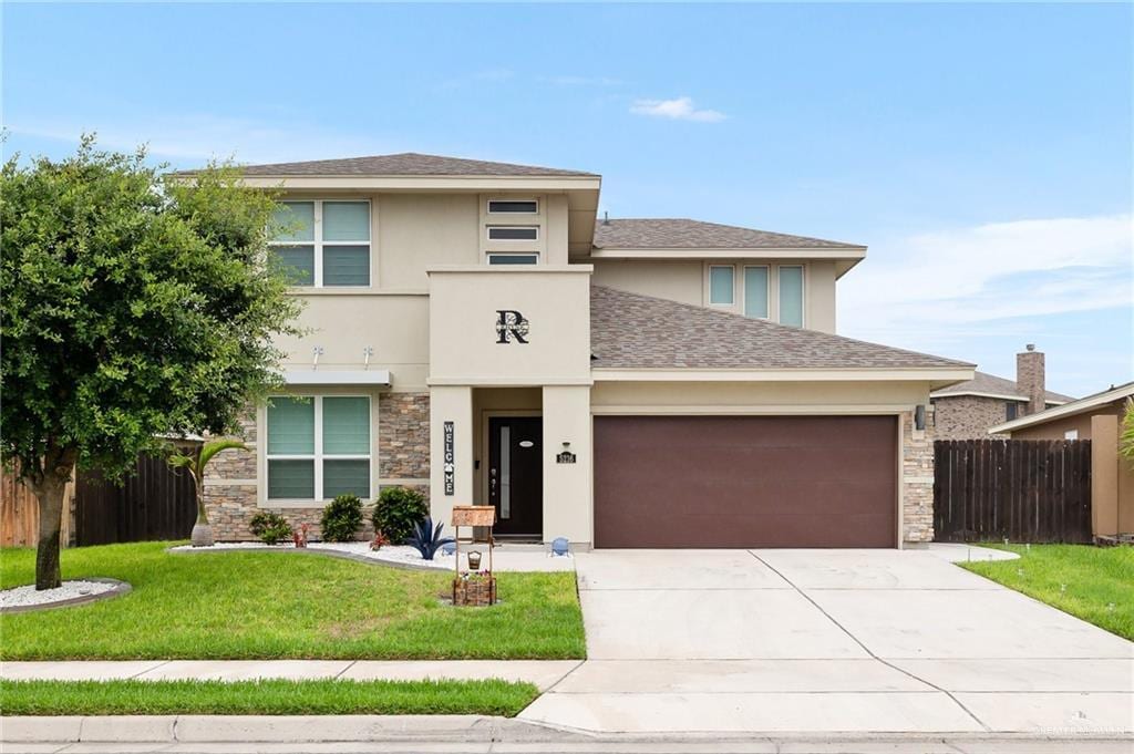 view of front of home with a garage and a front lawn