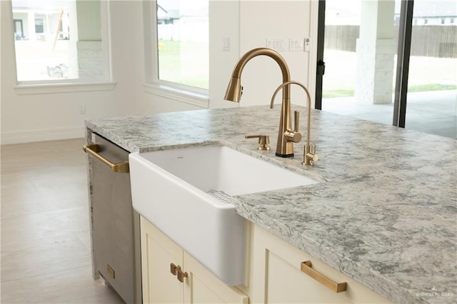 5407 Common Ln, Weslaco, TX 78596 - kitchen with a sink, stainless steel dishwasher, light stone counters, and baseboards