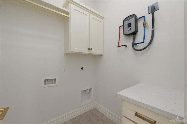 5407 Common Ln, Weslaco, TX 78596 - washroom with cabinet space, electric dryer hookup, hookup for a washing machine, baseboards, and light wood-style flooring