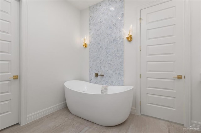 5407 Common Ln, Weslaco, TX 78596 - full bathroom with a freestanding tub, wood finished floors, and baseboards