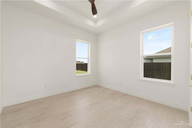 5407 Common Ln, Weslaco, TX 78596 - empty room featuring ceiling fan, baseboards, recessed lighting, light wood finished floors, and a raised ceiling