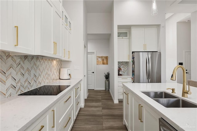 kitchen featuring decorative backsplash, sink, white cabinetry, and stainless steel appliances