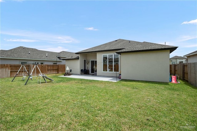 rear view of house featuring a lawn, a patio area, and a playground