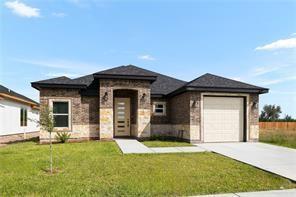 prairie-style house featuring an attached garage, a front yard, and concrete driveway