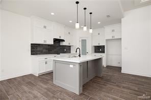 kitchen with white cabinets, light countertops, recessed lighting, and tasteful backsplash