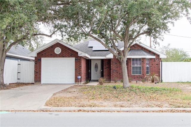 view of front of house featuring solar panels and a garage