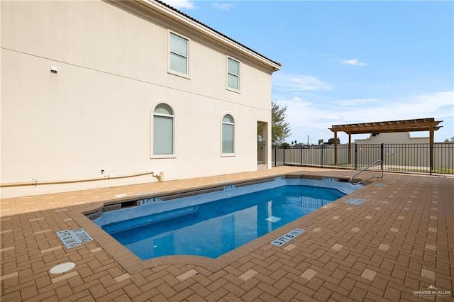 view of swimming pool with a patio and a pergola