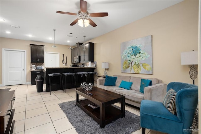 living room with ceiling fan and light tile patterned floors