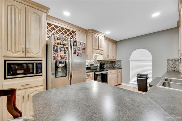 kitchen featuring stainless steel appliances, sink, decorative backsplash, and light brown cabinets