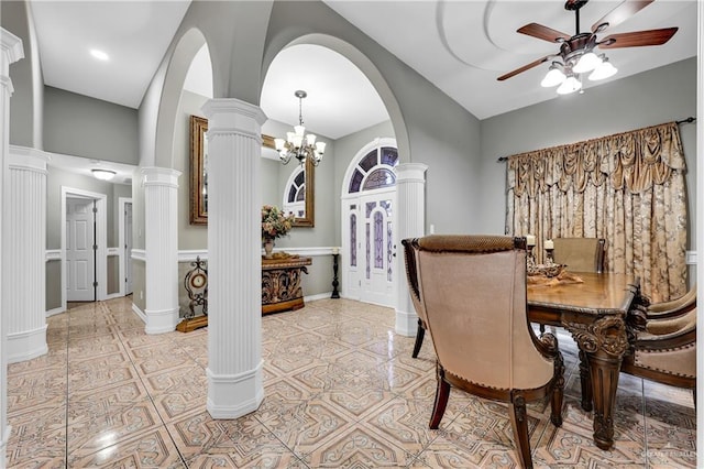 dining area featuring ornate columns, ceiling fan with notable chandelier, and light tile patterned floors