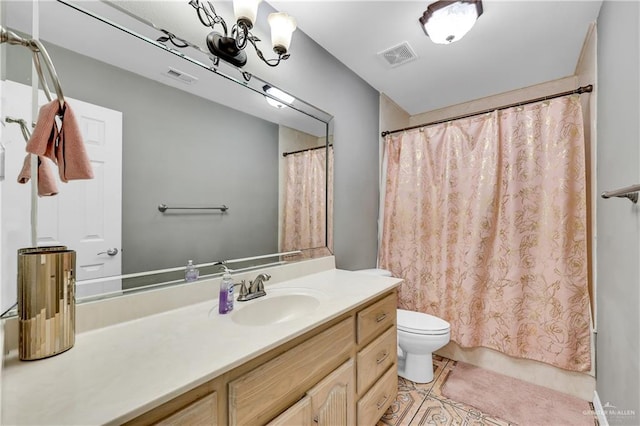 bathroom featuring vanity, toilet, and tile patterned flooring