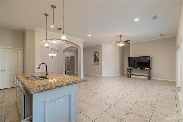 kitchen with visible vents, a sink, arched walkways, crown molding, and ceiling fan