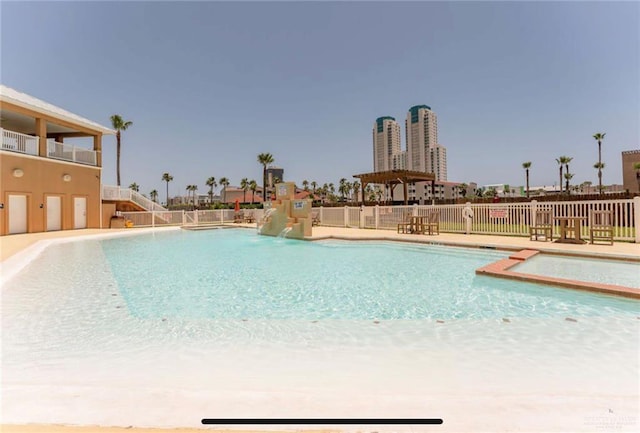 view of swimming pool featuring pool water feature