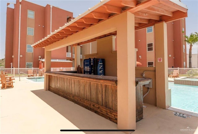 view of patio / terrace featuring a community pool and exterior bar