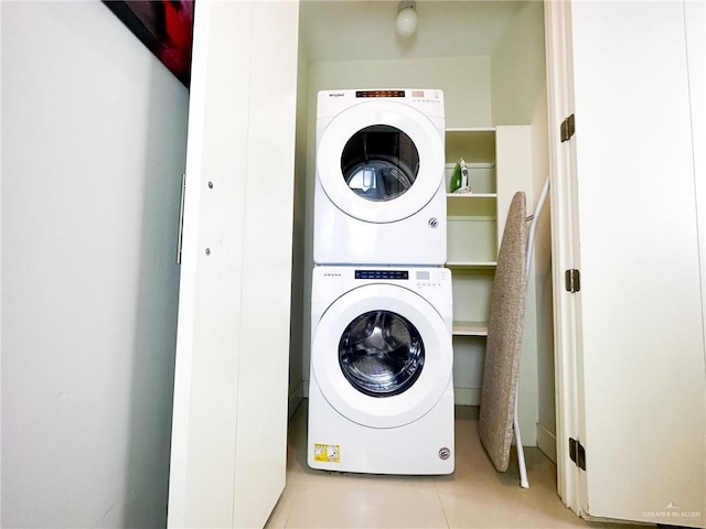 washroom featuring stacked washer and clothes dryer