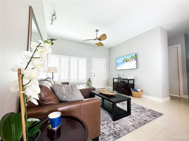 tiled living room with track lighting and ceiling fan