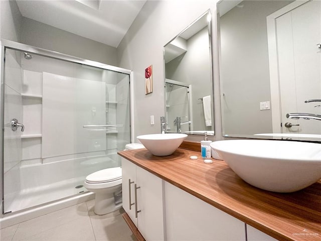 bathroom with an enclosed shower, vanity, tile patterned floors, and toilet