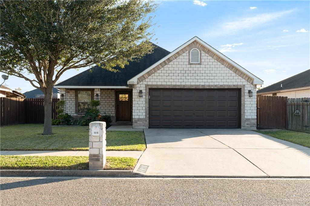 view of front of property with a front lawn and a garage