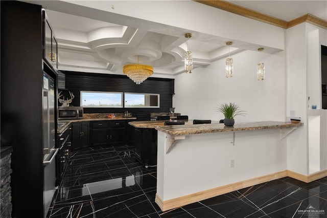 2115 Mile 3 N, Mercedes, TX 78570 - kitchen featuring stainless steel microwave, dark cabinets, light stone countertops, and a peninsula