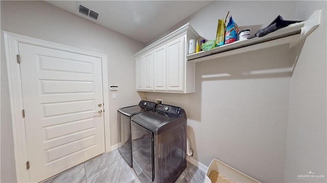 laundry area with cabinets and separate washer and dryer