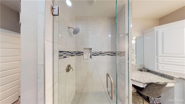 bathroom featuring a shower with shower door