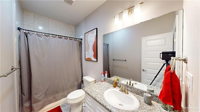 bathroom with vanity, toilet, and walk in shower