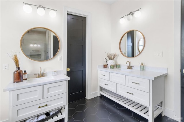 bathroom featuring tile patterned floors, two vanities, and a sink