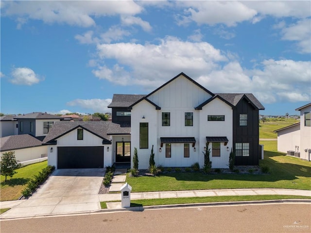 modern inspired farmhouse featuring a garage, board and batten siding, concrete driveway, and a front yard