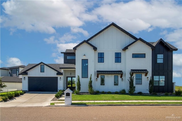 modern farmhouse with brick siding, board and batten siding, a front lawn, a garage, and driveway