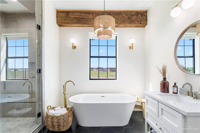 full bathroom with a healthy amount of sunlight, a stall shower, and vanity