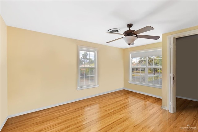 spare room with ceiling fan and light wood-type flooring