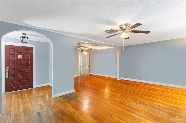 foyer featuring ceiling fan, hardwood / wood-style floors, and a textured ceiling