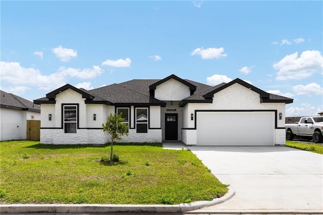 view of front of home featuring an attached garage, concrete driveway, a front yard, and fence