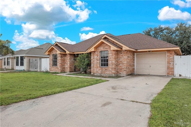 ranch-style house with a garage and a front lawn