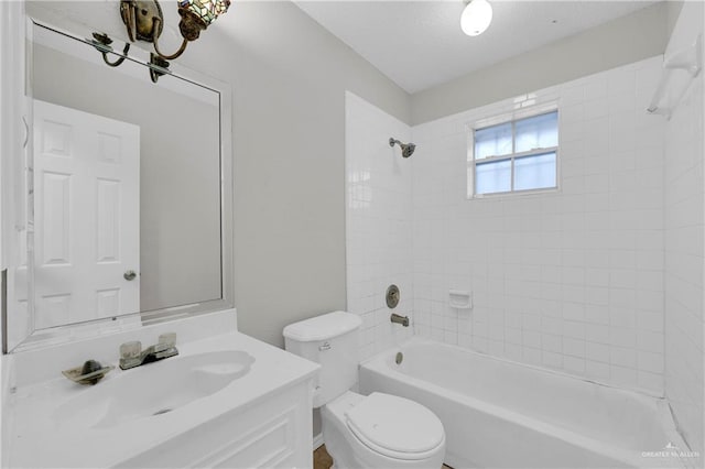 full bathroom featuring vanity, toilet, and tiled shower / bath combo