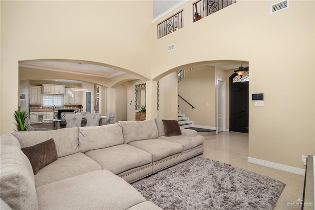 living room featuring light tile patterned floors and a high ceiling