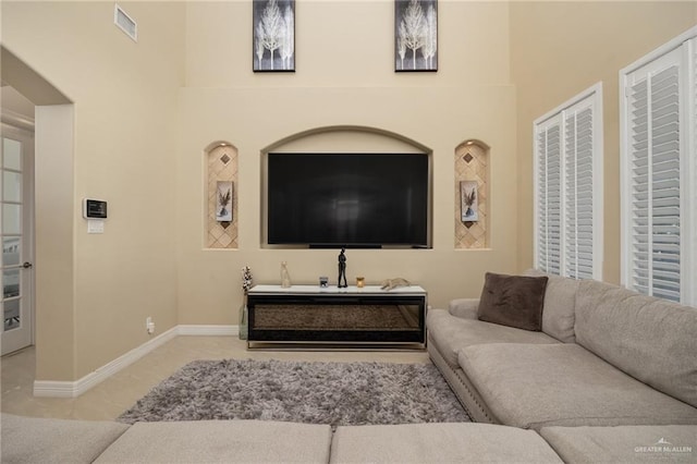 living room featuring a high ceiling