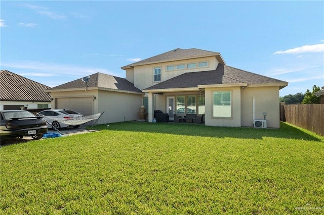 rear view of house with a garage and a lawn