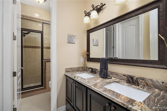 bathroom with toilet, vanity, and walk in shower