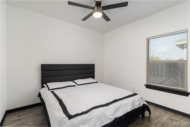 bedroom featuring ceiling fan and dark hardwood / wood-style flooring