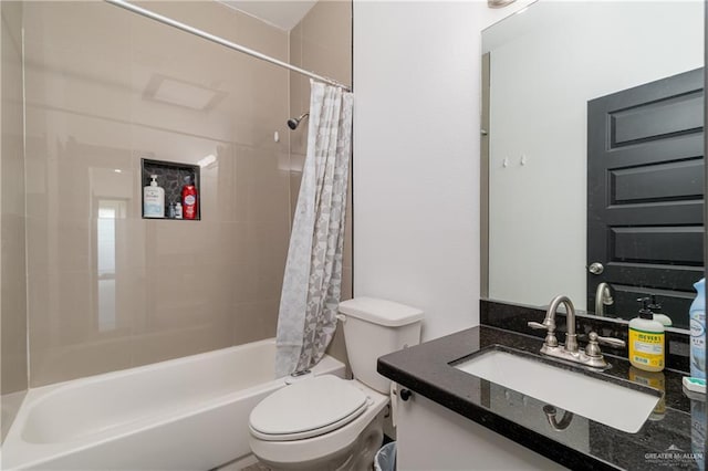 full bathroom featuring vanity, shower / bath combo, and toilet